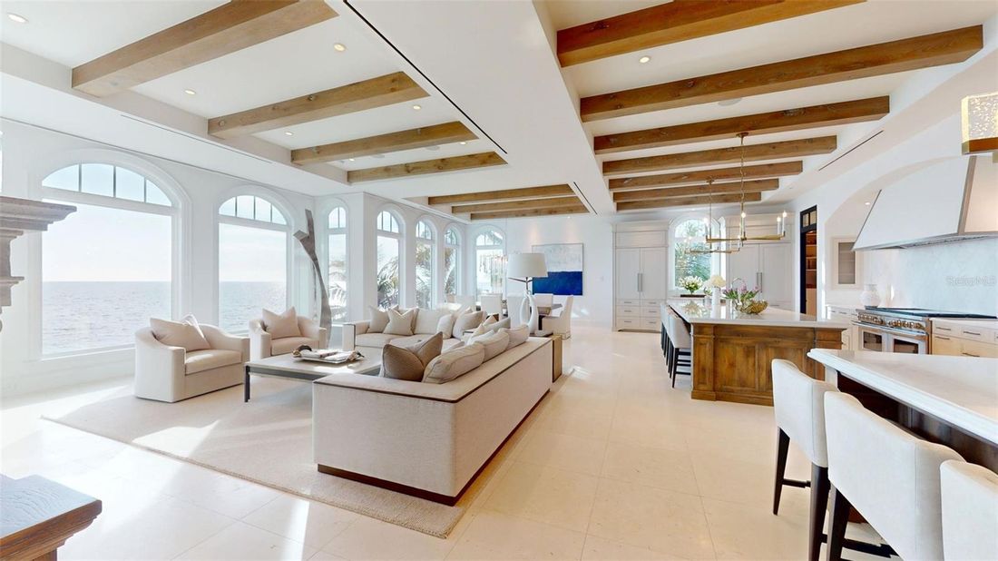 Living space behind arched windows facing the Gulf