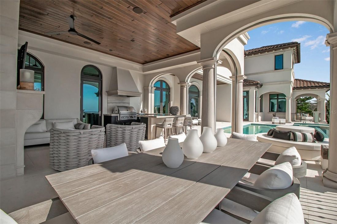 Covered loggia with outdoor dining and summer kitchen